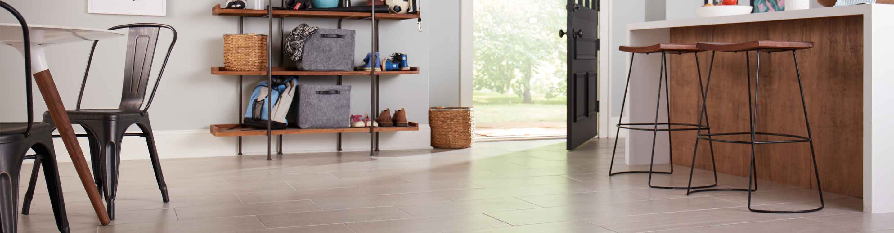 oversized large format tile flooring in kitchen with kitchen island and bar stools