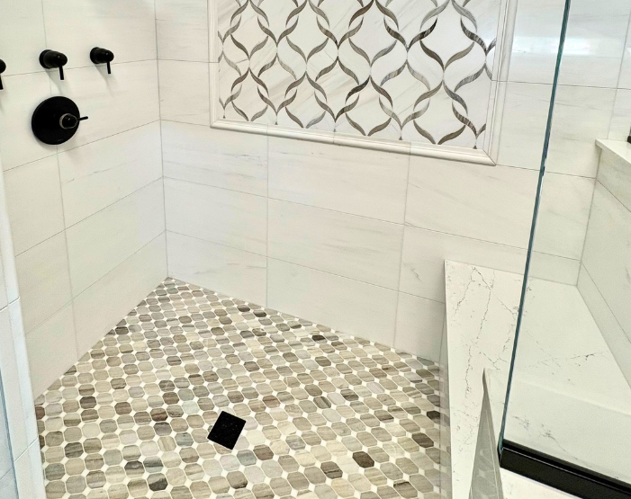 Custom tiled walk-in shower with bench at Northeast Flooring & Kitchens