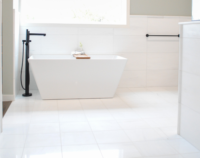 White tile flooring in a bathroom display at NEFK Kiba Studios